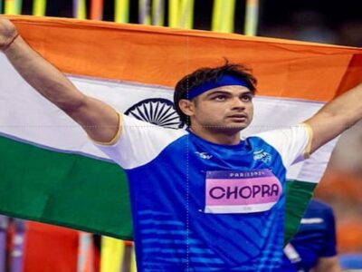 Neeraj Chopra with the Indian flag